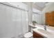 Bathroom with a toilet, sink, wood cabinet and shower with a white curtain at 213 Chimeneas Pl, Chapel Hill, NC 27517