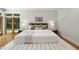 Beautiful bedroom with a bed, white ottoman bench, and backyard access at 213 Chimeneas Pl, Chapel Hill, NC 27517