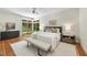 Bedroom featuring a large bed with neutral linens, a white bench, and a ceiling fan at 213 Chimeneas Pl, Chapel Hill, NC 27517