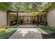Charming courtyard featuring brick flooring, columns, and lush greenery, providing a peaceful outdoor space to relax at 213 Chimeneas Pl, Chapel Hill, NC 27517