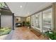 Welcoming covered patio with tiled floor and a 'Welcome' mat, offering a cozy outdoor space for relaxing and entertaining at 213 Chimeneas Pl, Chapel Hill, NC 27517