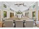 Open concept dining and living room, featuring modern light fixtures, tile flooring, and neutral walls at 213 Chimeneas Pl, Chapel Hill, NC 27517