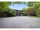 This home features mature landscaping, a long driveway, and an attached three-car garage at 213 Chimeneas Pl, Chapel Hill, NC 27517