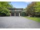 Two-story home with a wide driveway, two car garage, and mature landscaping; a welcoming entrance at 213 Chimeneas Pl, Chapel Hill, NC 27517