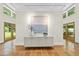 Bright foyer with neutral walls, striking painting, and tile flooring with beautiful outdoor views at 213 Chimeneas Pl, Chapel Hill, NC 27517