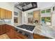 Beautiful kitchen design featuring stone fireplace, granite countertops, and stainless steel appliances at 213 Chimeneas Pl, Chapel Hill, NC 27517