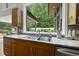 Kitchen with granite countertops, stainless steel appliances, and a large window overlooking the backyard at 213 Chimeneas Pl, Chapel Hill, NC 27517
