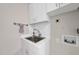 Laundry room features a stainless steel sink, white cabinetry, and neutral walls, offering a clean and efficient space at 213 Chimeneas Pl, Chapel Hill, NC 27517