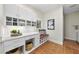 Well-organized laundry room with built-in storage, countertop space, a cushioned seating nook, and tiled floor at 213 Chimeneas Pl, Chapel Hill, NC 27517