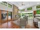 Bright living room featuring a stone fireplace, tile floors, and sliding glass doors leading to the backyard at 213 Chimeneas Pl, Chapel Hill, NC 27517