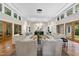 Large living room featuring comfortable couches, overhead projector, many windows, and tile floors at 213 Chimeneas Pl, Chapel Hill, NC 27517