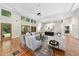 Bright living room with neutral couches and many windows with beautiful outdoor views and tile flooring at 213 Chimeneas Pl, Chapel Hill, NC 27517