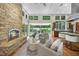 Cozy living room featuring a stone fireplace, tile floors, and open access to kitchen at 213 Chimeneas Pl, Chapel Hill, NC 27517