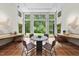 Bright sunroom with tiled floor, multiple windows, and an outdoor view at 213 Chimeneas Pl, Chapel Hill, NC 27517