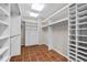 Walk-in closet with custom shelving, drawers, and hanging rods provides ample storage at 213 Chimeneas Pl, Chapel Hill, NC 27517