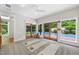 Bright yoga room boasts a wall of windows overlooking the pool area at 213 Chimeneas Pl, Chapel Hill, NC 27517