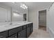 Bathroom with dual vanity sinks, dark cabinets and walk-in closet access at 2177 Campbell, Burlington, NC 27215