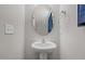 Powder room with pedestal sink and oval mirror at 2177 Campbell, Burlington, NC 27215