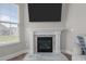 Close up of an elegant fireplace with marble accents and a wall-mounted TV at 2177 Campbell, Burlington, NC 27215