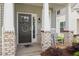 Inviting front porch with brick accents and a welcoming rocking chair at 2177 Campbell, Burlington, NC 27215