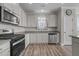 Well-appointed kitchen with modern appliances, white cabinets, and wood floors at 2177 Campbell, Burlington, NC 27215
