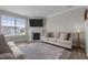 Cozy living room with hardwood floors, a fireplace, and large windows for natural light at 2177 Campbell, Burlington, NC 27215