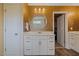 Well-lit bathroom showcases a vanity with white cabinets and a framed round mirror at 2713 Jazzy St, New Hill, NC 27562