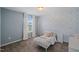 Bright bedroom featuring a beautiful accent wall and a cozy daybed next to the window at 2713 Jazzy St, New Hill, NC 27562