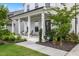 Charming front porch with cozy seating, manicured landscaping, and an inviting entrance at 2713 Jazzy St, New Hill, NC 27562