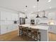 Modern kitchen featuring a large island, stainless steel appliances, and sleek white cabinetry at 2713 Jazzy St, New Hill, NC 27562