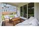 Cozy screened-in porch with comfortable seating, offering views of the backyard and home exterior at 2713 Jazzy St, New Hill, NC 27562