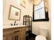 Bright bathroom features a modern vanity, mirror, natural light, and toilet at 275 Gholson Ave, Henderson, NC 27536