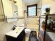 Neat bathroom with tiled walls and a modern vanity at 275 Gholson Ave, Henderson, NC 27536