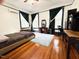 Bright bedroom featuring hardwood floors, large windows, and ample space for relaxing and work at 275 Gholson Ave, Henderson, NC 27536