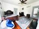 Spacious bedroom with hardwood floors, decorative rug, and modern ceiling fan and a large beanbag chair at 275 Gholson Ave, Henderson, NC 27536