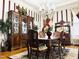 Formal dining room with vintage chandelier, classic furniture, and elegant decor at 275 Gholson Ave, Henderson, NC 27536