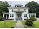 Charming two-story home with a well-maintained lawn and beautiful white exterior at 275 Gholson Ave, Henderson, NC 27536