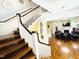 Grand foyer with sweeping staircase and chandelier at 275 Gholson Ave, Henderson, NC 27536