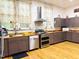 Well-equipped kitchen with a stainless steel range hood, appliances, and wood countertops at 275 Gholson Ave, Henderson, NC 27536