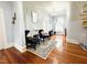 Inviting living room showcasing hardwood floors, chandelier, and comfortable seating near a large window at 275 Gholson Ave, Henderson, NC 27536