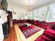 Unique living room features gorgeous flooring, bay windows, an ornate chandelier, and custom seating at 275 Gholson Ave, Henderson, NC 27536