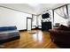 Cozy living room with hardwood flooring, a decorative fireplace, and comfortable seating at 275 Gholson Ave, Henderson, NC 27536