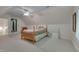 Spacious bedroom with wooden bed frame, carpeted flooring and access to the bathroom at 300 Williamston Ridge Dr, Youngsville, NC 27596