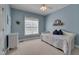Bright blue bedroom with daybed, ceiling fan and natural light at 300 Williamston Ridge Dr, Youngsville, NC 27596
