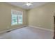 This cozy bedroom has neutral carpeting, a ceiling fan, and natural light at 300 Williamston Ridge Dr, Youngsville, NC 27596