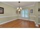 Elegant dining room featuring hardwood floors, chandelier, and ample natural light at 300 Williamston Ridge Dr, Youngsville, NC 27596