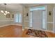 Inviting foyer with hardwood floors, decorative rug, and an abundance of natural light at 300 Williamston Ridge Dr, Youngsville, NC 27596