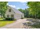 View of the home's side exterior showcasing a garage and wide driveway at 300 Williamston Ridge Dr, Youngsville, NC 27596
