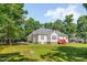 A shot of the house exterior from the backyard; a lovely two-story home with beautiful lawn and landscaping at 300 Williamston Ridge Dr, Youngsville, NC 27596