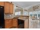 Kitchen sink with wood cabinets and black appliances looking into the dining area at 300 Williamston Ridge Dr, Youngsville, NC 27596